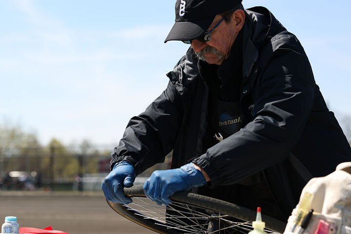 A Little 500 mechanic works on fixing a tire.